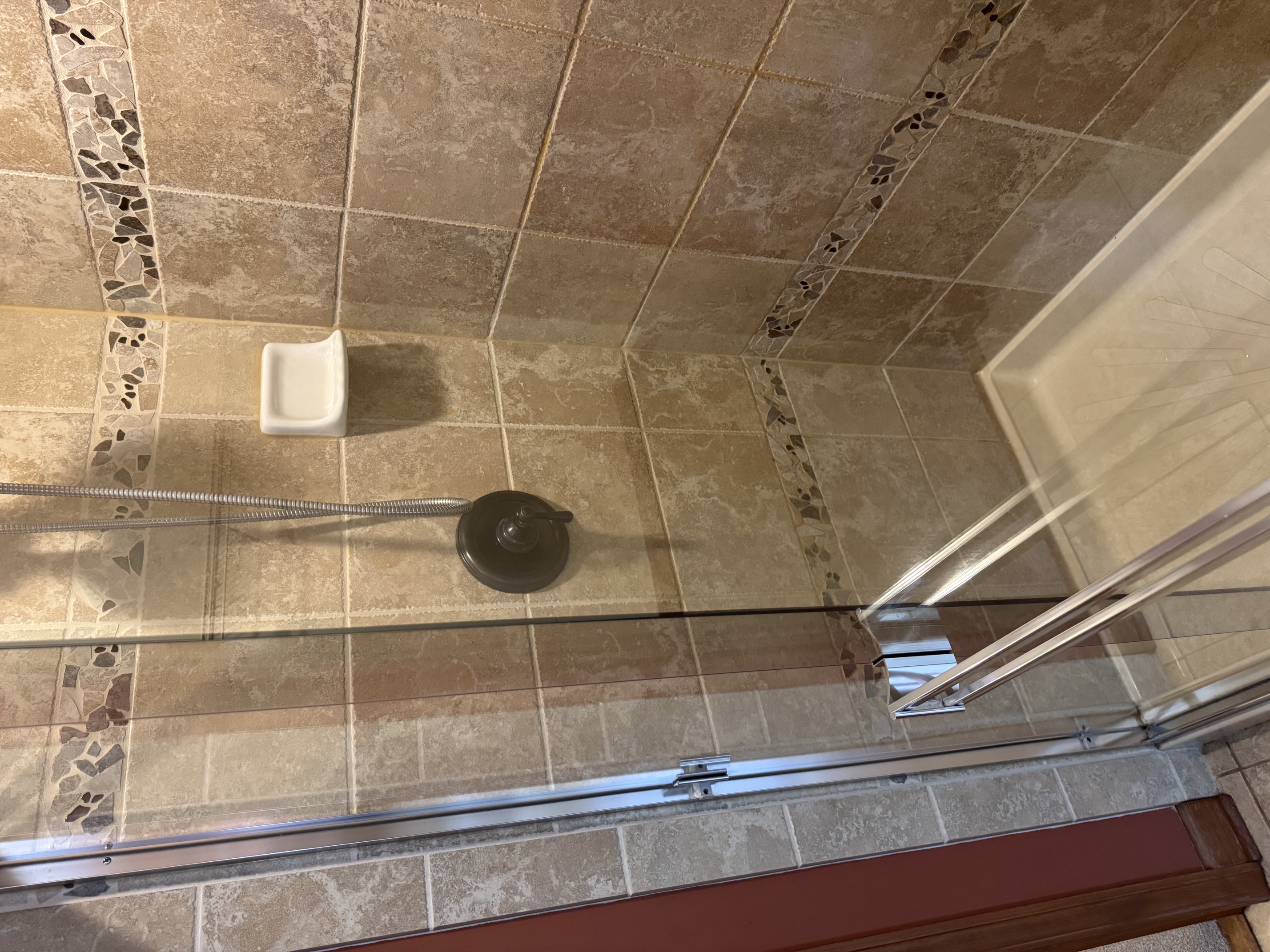 Clear glass shower door after Kaizen Klean deep cleaning